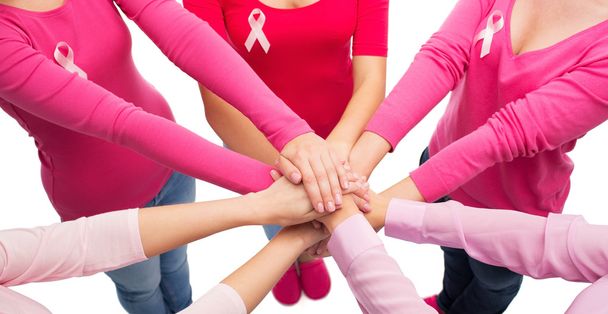 close up of women with cancer awareness ribbons - 写真・画像