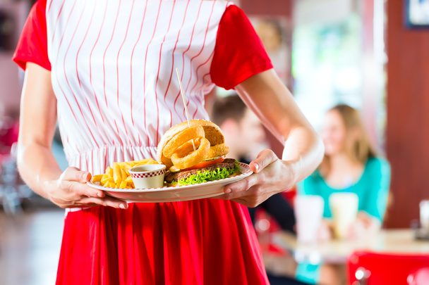 Az emberek az amerikai diner gyorséttermi étkezés - Fotó, kép