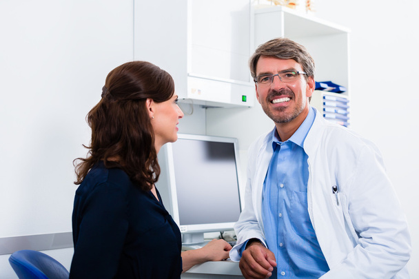 General practitioner in doctors office seeing patient - Photo, Image