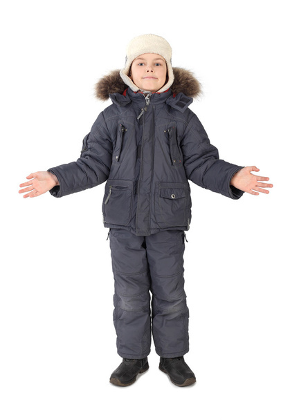 Little boy in winter dress standing on white background hands at - Photo, image