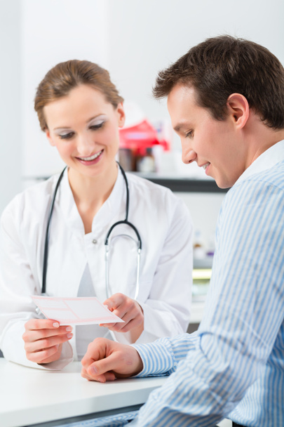 Doctor with patient in clinic consulting  - Photo, Image