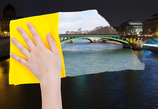 hand deletes night view of Paris by yellow cloth - 写真・画像