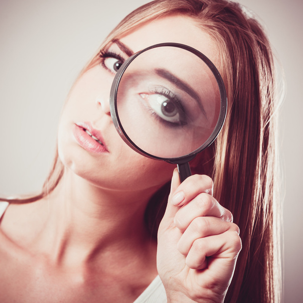 Girl holding on eye magnifying glass - Foto, immagini