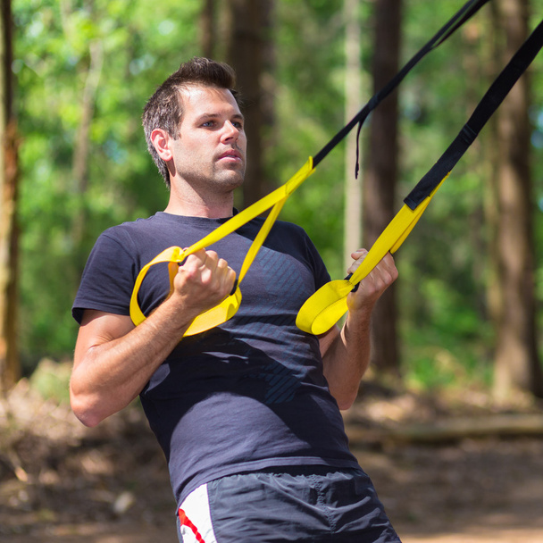 Training with fitness straps outdoors. - Photo, Image