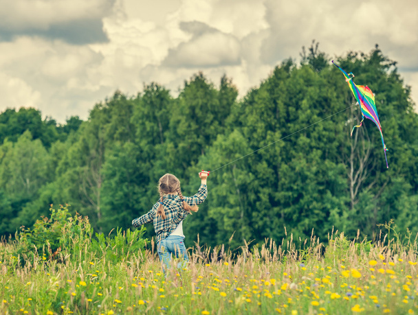 Little cute girl flying  kite - Fotó, kép