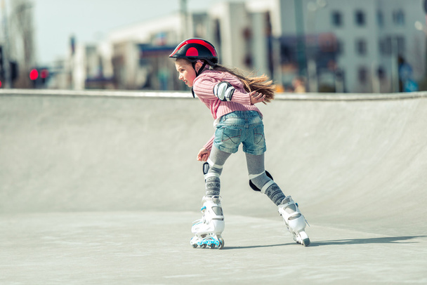 Little pretty girl on roller skates  - Φωτογραφία, εικόνα