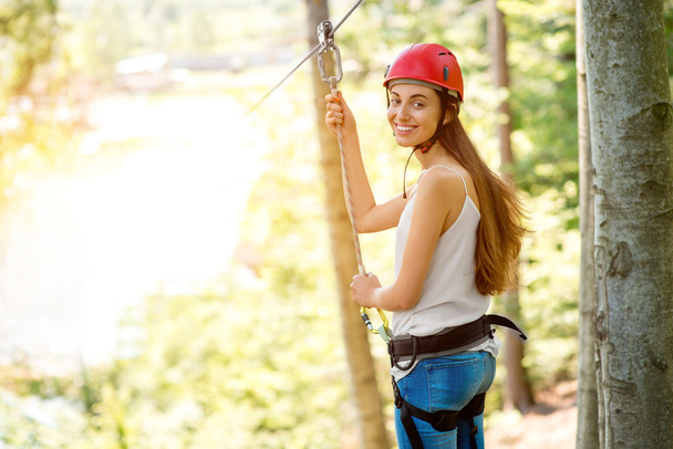 Woman riding on a zip line - Photo, Image