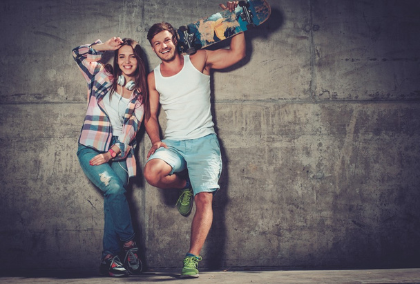 couple with skateboard  outdoors - Photo, Image