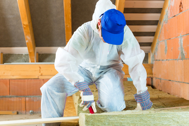 Worker cutting insulating material - Photo, Image