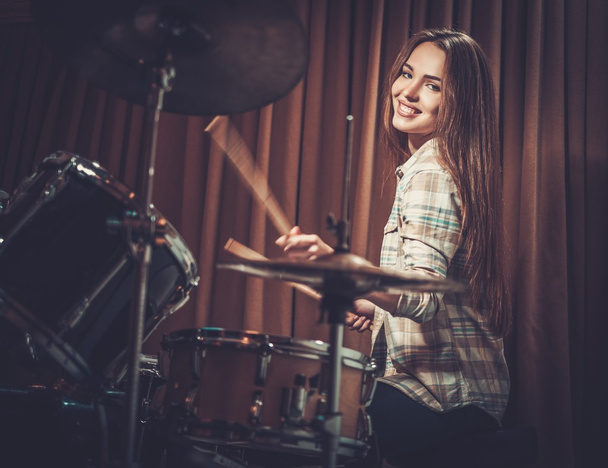 cheerful girl behind drums on a rehearsal - Fotoğraf, Görsel