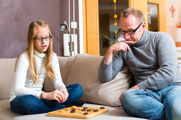 Father and daughter playing checkers - Photo, Image