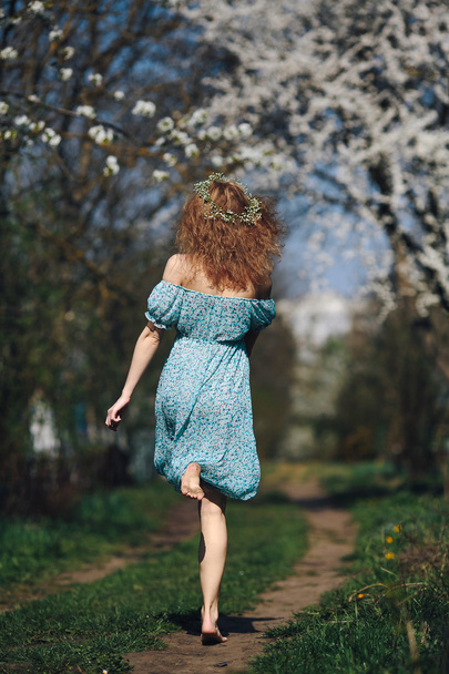 Beautiful girl follows a country road - 写真・画像