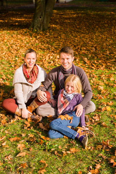 Happy Family outdoors sitting on grass in autumn - Φωτογραφία, εικόνα