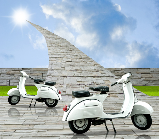 Retro scooter with stone road to sun - Фото, изображение