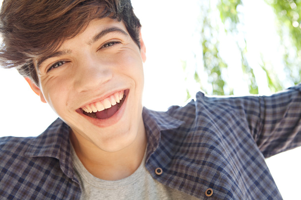 portrait of a teenager boy joyfully smiling - 写真・画像