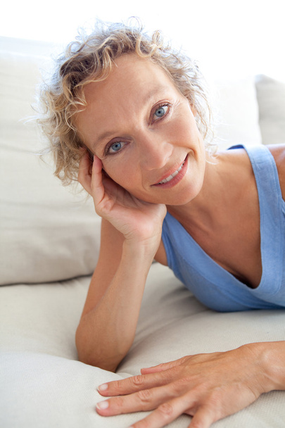 donna rilassante su un divano bianco a casa
 - Foto, immagini