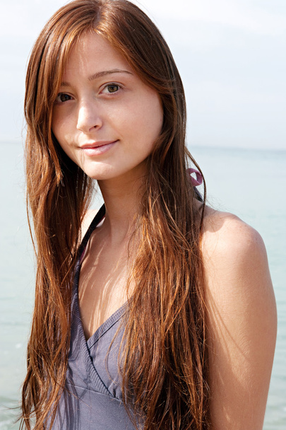 attractive teenager girl standing on a beach - Zdjęcie, obraz