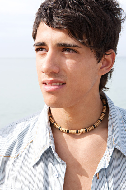 portrait of an attractive teenager boy on a beach - Foto, afbeelding