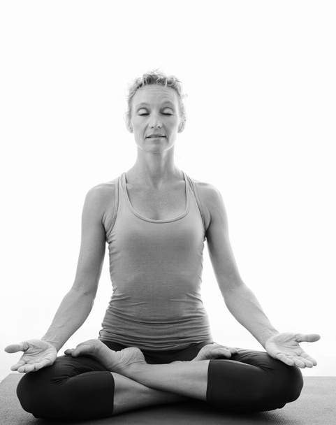 woman in a yoga position stretching and meditating - Φωτογραφία, εικόνα