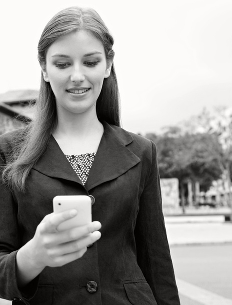 businesswoman using smartphone in a city - Photo, Image