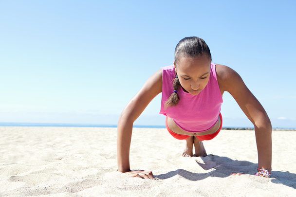 woman exercising on a sand beach - Photo, Image