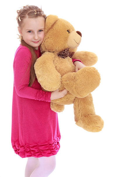 Pretty girl holding bear - Фото, зображення