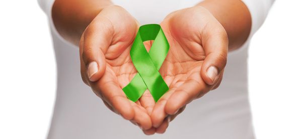 hands holding green awareness ribbon - Foto, immagini