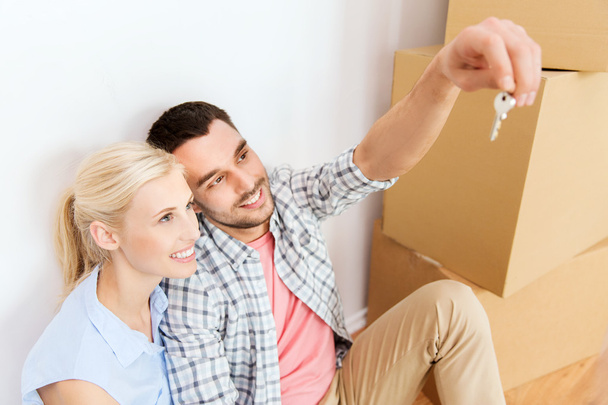 couple with key and boxes moving to new home - Photo, Image