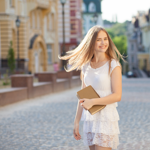 Girl with book on street - Valokuva, kuva
