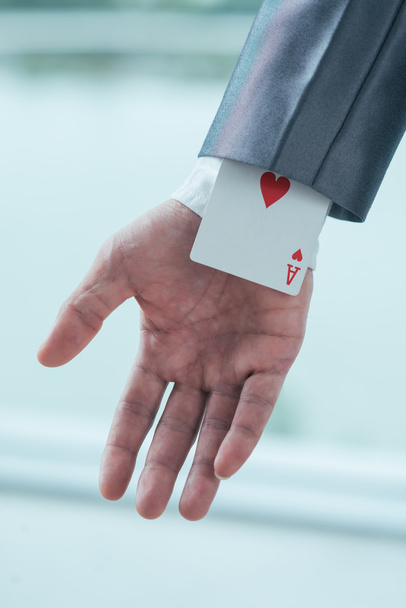 businessman having ace of hearts in his sleeve - Zdjęcie, obraz