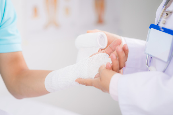 Doctor bandaging wrist - Photo, Image