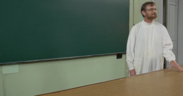 Professor, Man, Chemist, Biologist in White Medical Robe is Holding the Class, Lecture at the Teacher's Desk, Walking toward the Door, Corridor - Footage, Video