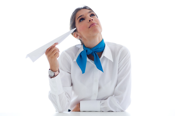Beautiful hostess holding paper airplane. Isolated on white. - Foto, Imagem