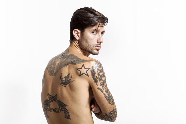 Sexy tattooed man back portrait looking at camera - Фото, зображення