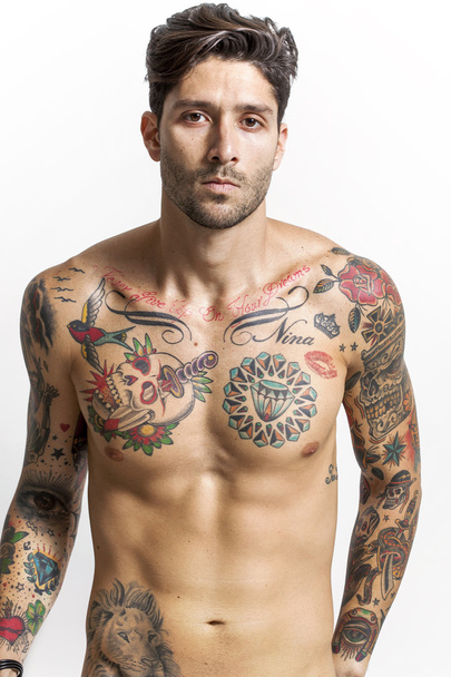 Handsome and sexy tattooed man looking at camera - Foto, Imagen