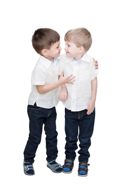 Four-year-old boys of twins, in white linen shirts, one embraces another, isolated on the white - Foto, imagen