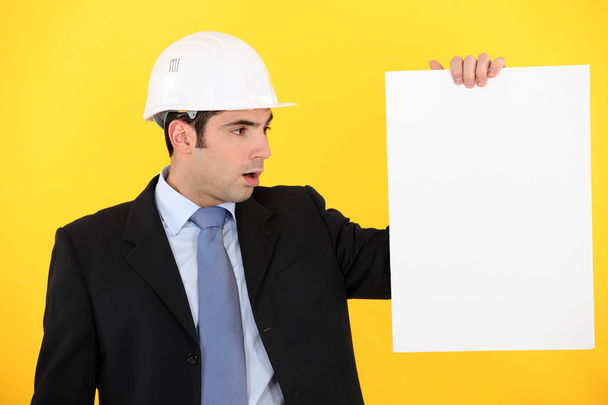 Architect stood with blank poster - Photo, Image