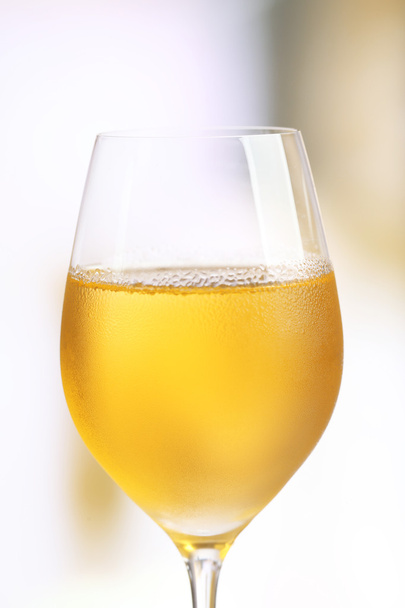 Glass of wine on light blurred background - Foto, Imagem
