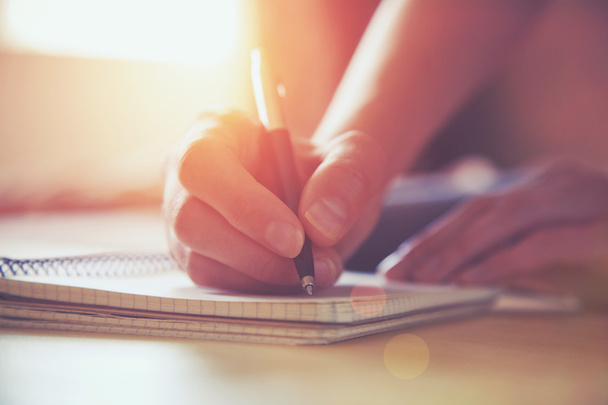 female hands with pen writing on notebook - Zdjęcie, obraz