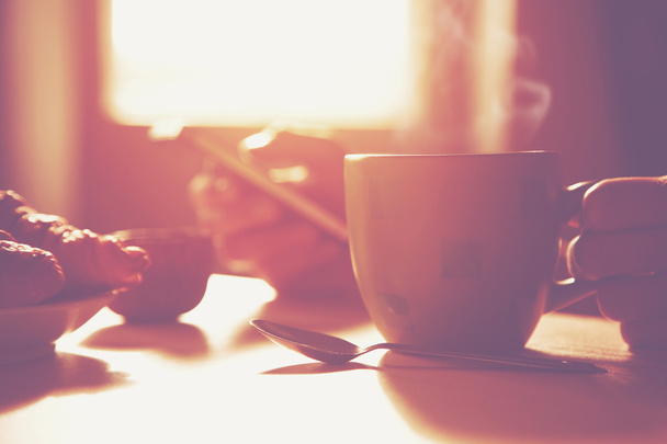 Fresh breakfast with hot coffee and browsing smartphone - Foto, Bild