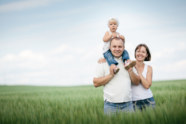 parents with daughter in the field - Foto, immagini