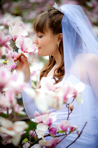 Young bride among the flowers - Фото, зображення