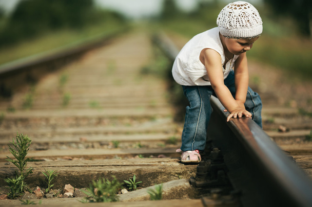 little girl plays on railroad - 写真・画像