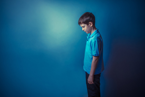 Boy teenager European appearance ten years standing sideways loo - Фото, изображение
