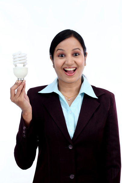Young Indian business woman holding bulb  - Фото, зображення