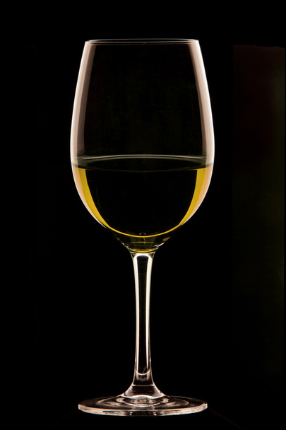 Glass of wine on black background. - Foto, afbeelding