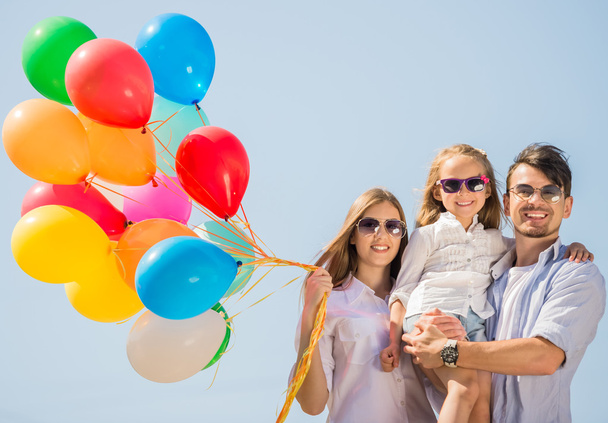 Family with balloons outdoors - Fotó, kép