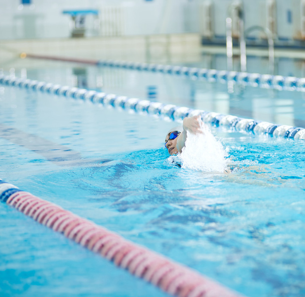 Young girl in goggles swimming front crawl stroke style - Photo, Image