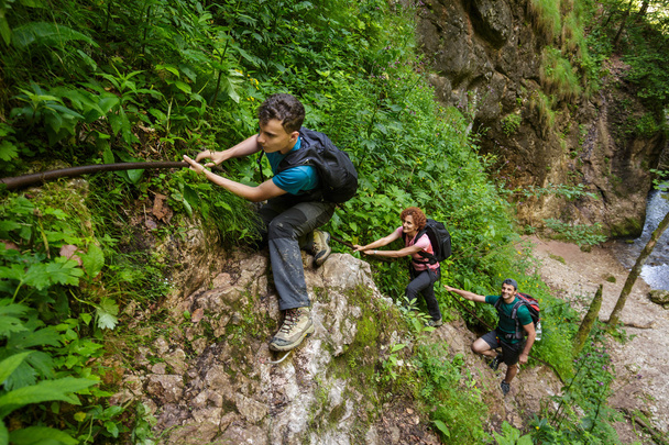 hikers climbing on safety cables - Fotó, kép