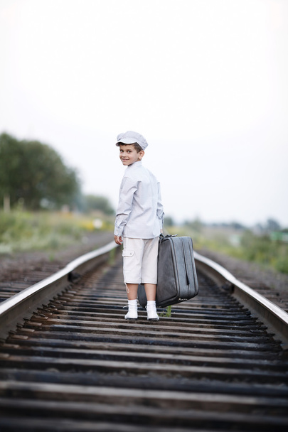 boy with suitcase on railroad - Fotoğraf, Görsel